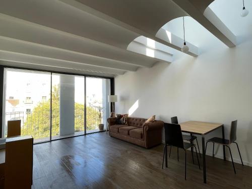 sala de estar con sofá y mesa en loft en el centro en Vilanova i la Geltrú