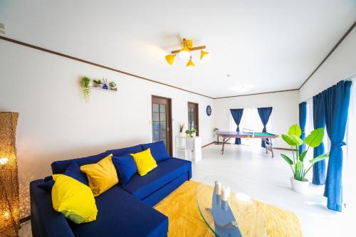 a living room with a blue couch and yellow pillows at Yokkaichi - House - Vacation STAY 14171 in Yokkaichi