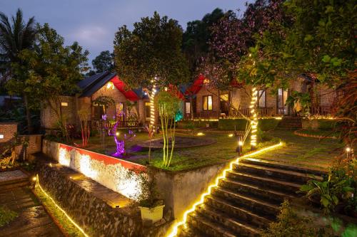 a garden with lights and stairs at night at Cat Ba Spring Garden Homestay in Cat Ba