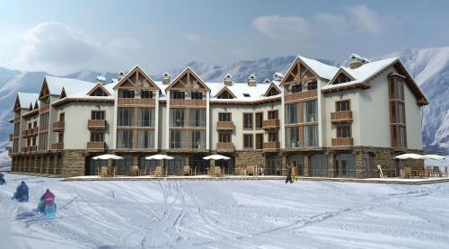 um grande edifício na neve com uma pessoa na frente em Baka's Apartment in Gudauri em Gudauri