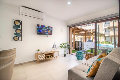a living room with a couch and a table at Ambar Condominios Mazatlan in Mazatlán