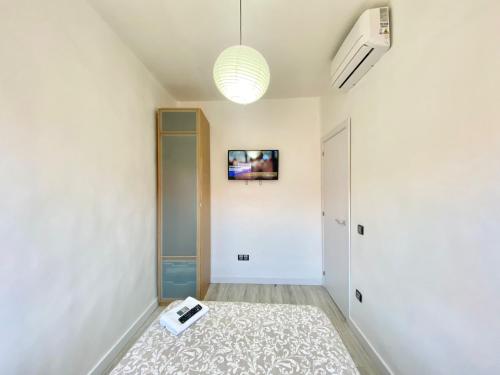 a hallway with a room with a tv on the wall at Piramides 1 Apartment in Madrid