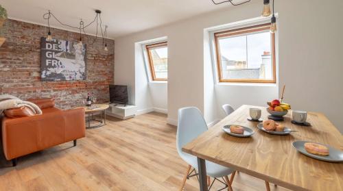 a dining room and living room with a table and chairs at Cracking Central Loft Apartment, Old Town in Hastings