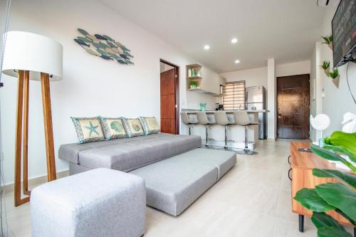 a living room with a couch and a table at Ambar Condominios Mazatlan in Mazatlán