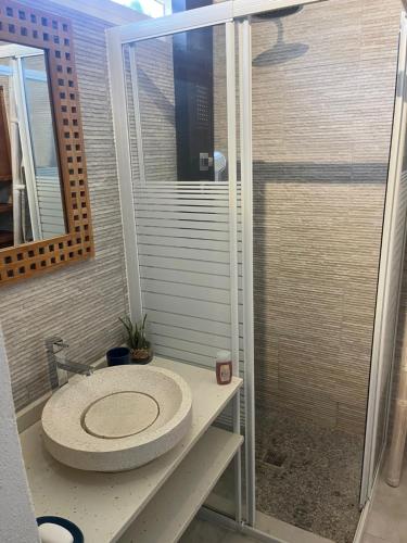 a bathroom with a shower with a toilet in it at Villa vue mer 180°, piscine in Saint-François