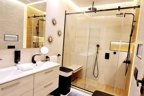 a bathroom with a shower and a sink at Ain diab- luxury appart hotel LRM ,free parking in Casablanca