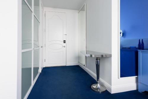 a bathroom with a blue floor and a sink at NoMo SoHo in New York