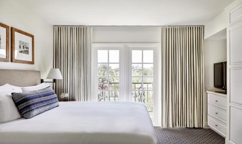 a bedroom with a bed and a large window at Arizona Grand Resort in Phoenix