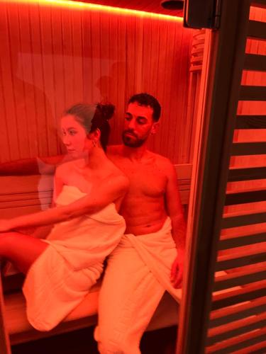 a man and a woman sitting on a bed at Centro Storico in Pozzuoli