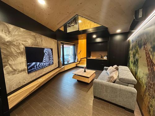 a living room with a couch and a tv at tvrz KRASSA in Osečná