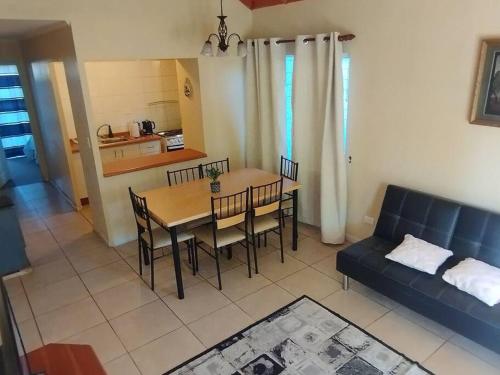 a living room with a table and chairs and a couch at Casa de la Ribera Rengo in Valdivia