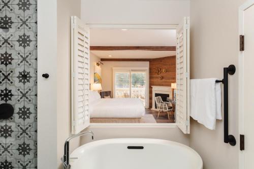 a bathroom with a sink and a bed in a room at The Lodge at Healdsburg, Tapestry Collection by Hilton in Healdsburg