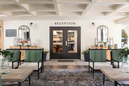 a lobby with a black door and tables and chairs at The Lodge at Healdsburg, Tapestry Collection by Hilton in Healdsburg