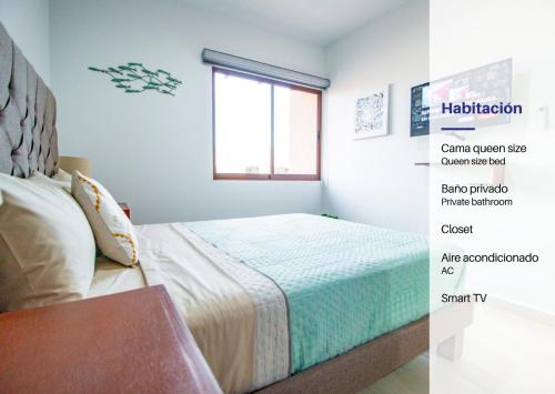 a bedroom with a bed and a window at Ambar Condominios Mazatlan in Mazatlán