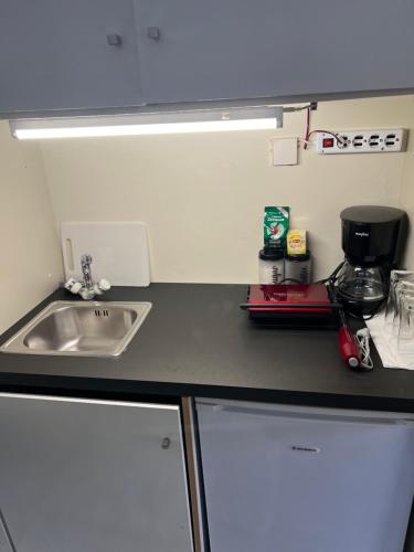 a kitchen with a sink and a counter top at Smile studio in Drama