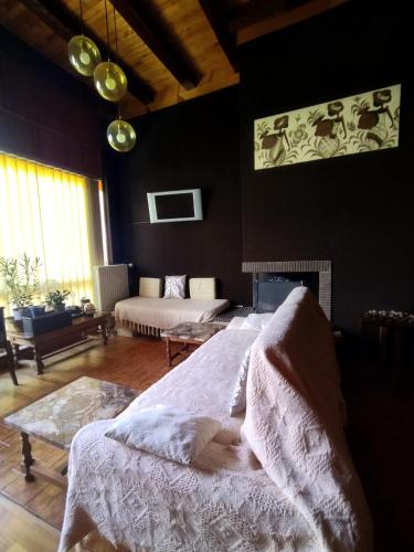 a bedroom with a bed and a living room at NOMAD ALP B&B in Marthod