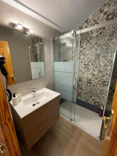 a bathroom with a sink and a shower at ATICO BUENAVISTA in Ardales
