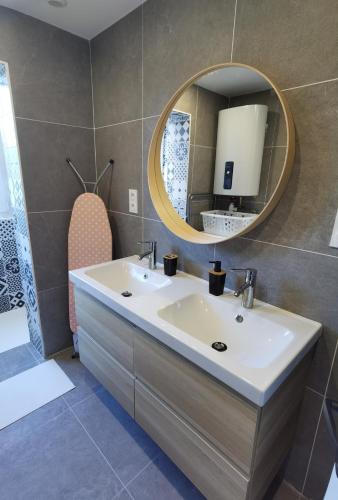 uma casa de banho com um lavatório e um espelho em Quatre Moulins - 3 chambres - WIFI - Refait à neuf em Brest