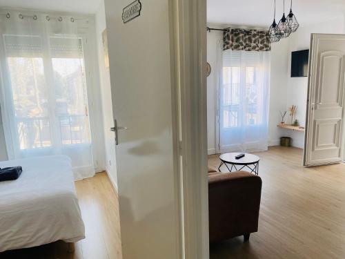 a bedroom with a bed and a chair in a room at Le bon coin in Le Creusot