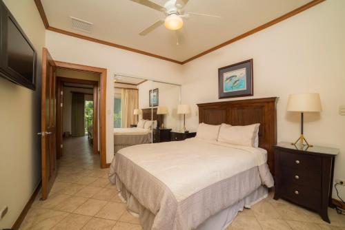 a bedroom with a bed and a ceiling fan at Los Suenos Resort Veranda 2C by Stay in CR in Herradura