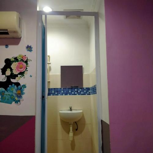 a bathroom with a toilet and a sink at 1st Inn Hotel Glenmarie in Shah Alam