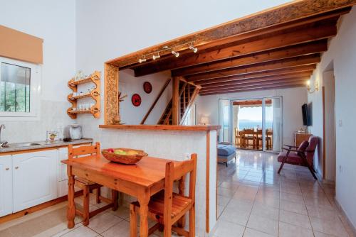 a kitchen with a table and a dining room at Aphrodite's maisonette on Corfu island in Barbati