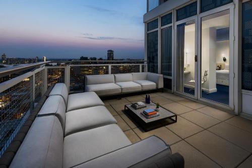 a balcony with a couch and a table on a building at NoMo SoHo in New York