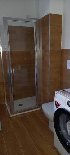 a bathroom with a shower and a toilet and a sink at Spilamberto 6b - 12mins from San Donato M3 station in San Donato Milanese