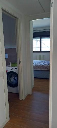 a room with a bedroom with a bed and a door at Spilamberto 6b - 12mins from San Donato M3 station in San Donato Milanese