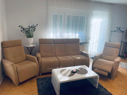a living room with a couch and two chairs and a table at RELAX APPARTEMENT - Graz in Graz