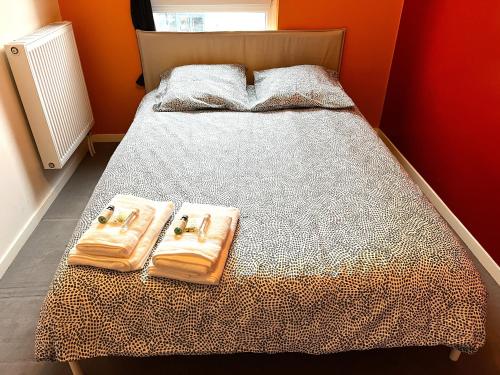 a bedroom with a bed with two towels on it at Paris La-Defense - U Arena - 2 Bedrooms - Parking, Terrace & Wifi in Nanterre