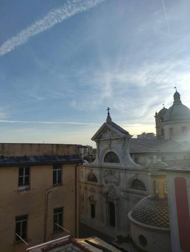a building with a cross on the top of it at La Mansarda di Vico Mandorla in Savona