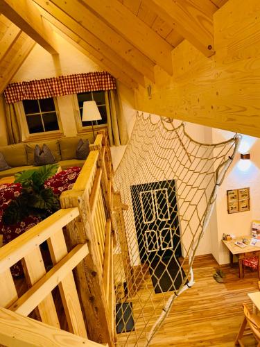an attic room with a bed and a staircase at Bergheimat in Bad Goisern