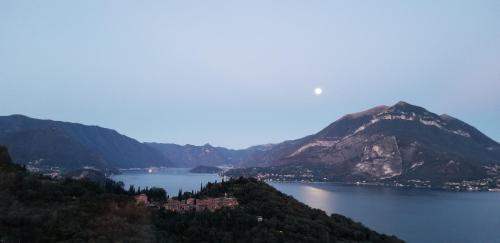 a view of a large body of water with mountains at Trilly House in Perledo