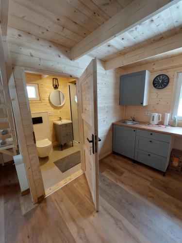 a bathroom in a log cabin with a sink and a toilet at Sudecka Wiata-Domki in Głuszyca