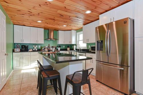 a kitchen with white cabinets and a stainless steel refrigerator at *NEW* Beautiful 3 floor Townhome with Sauna in Manchester