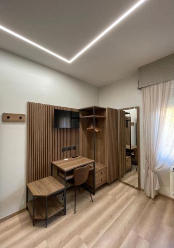 a room with a desk and a table and a chair at Villa Noce in Brescia