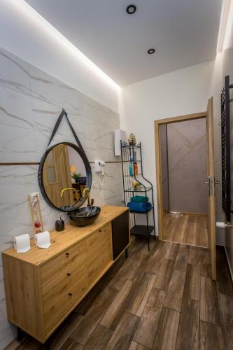 a dressing room with a mirror and a wooden dresser at Apartamenty centrum in Wałbrzych