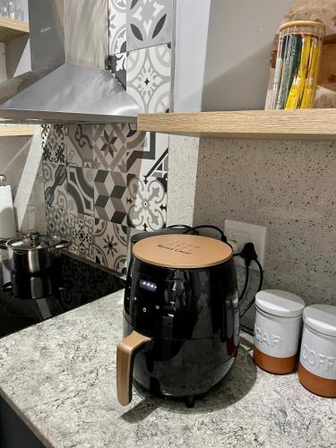 a slow cooker sitting on a counter in a kitchen at Mdumela Stays 2 Bedroom Modern City Apartment in Pietermaritzburg