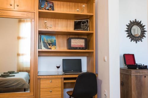 - une chambre avec un bureau et un ordinateur dans une étagère dans l'établissement Niochori Heritage: The Pianist Suite, à Rhodes
