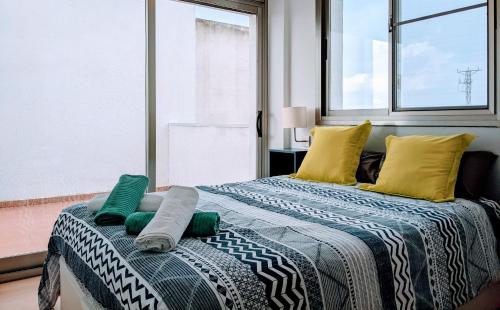 a bedroom with two beds with pillows and a window at Ca Na Vinyet in El Poblenou del Delta