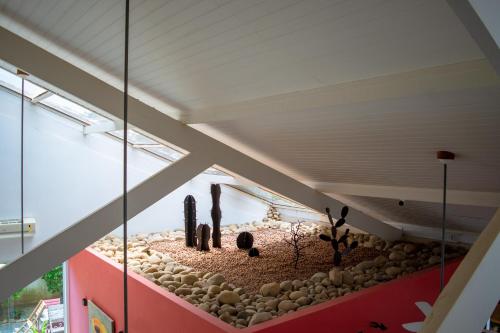a room with a display of rocks and cactus at Pousada da Cyssa in Búzios