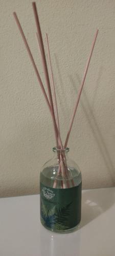 a glass jar with bamboo sticks in it at DIMORA AL SARACENO in Ferrara