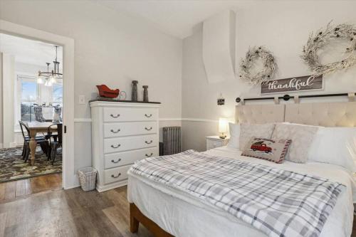 a bedroom with a bed and a dresser and a table at Farmhouse Near Little Bavaria in Frankenmuth