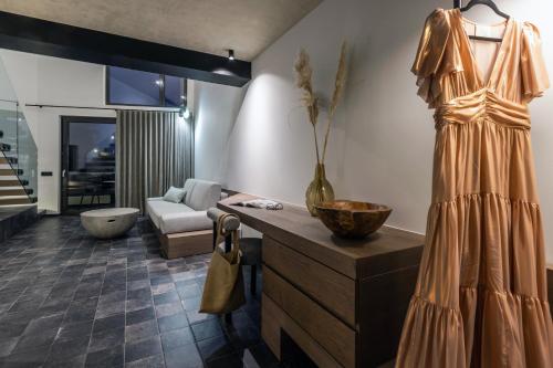 a dress hanging on a wall in a living room at ACRO Upscale Residences in Kórinthos