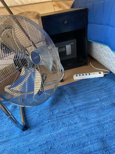 a fan and a remote control next to a router at CaminAndes Hostal in San Pedro de Atacama