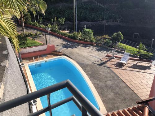 a view of a swimming pool on a balcony at 2 bedrooms apartement with sea view private pool and enclosed garden at Lombo Do Doutor 1 km away from the beach in Calheta