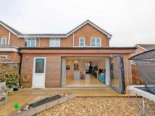 a house extension with sliding doors on a patio at The Rock House in Chichester