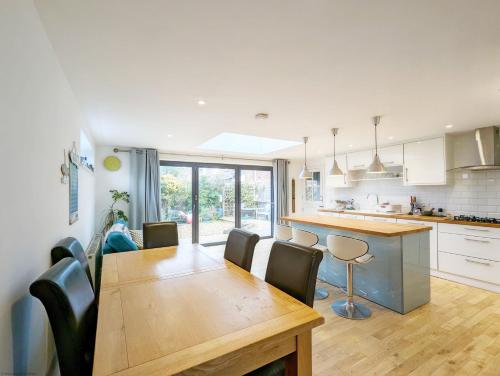 a kitchen and dining room with a table and chairs at The Rock House in Chichester