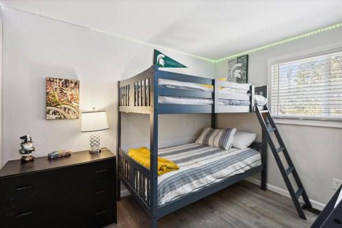 a bedroom with a bunk bed and a desk at Pet-Friendly Large-Group Oasis in Bay City